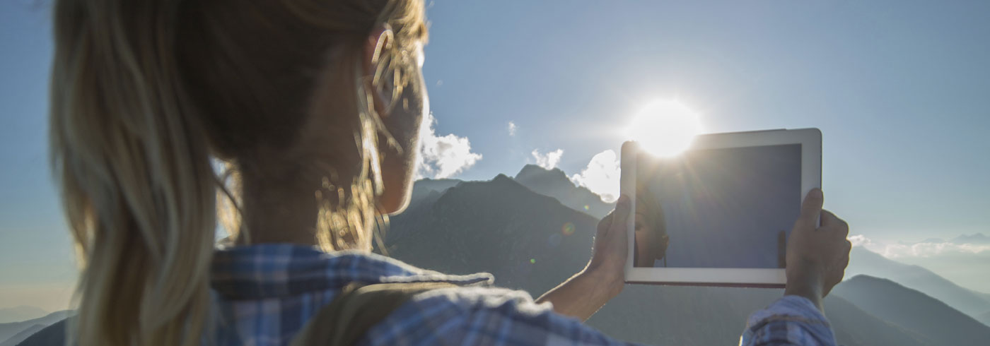 girl-holding-tablet-outside